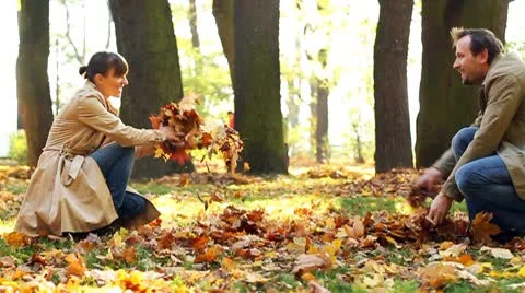 Young couple having fun in beautiful autumn park, slow motion Stock Footage 8950733
