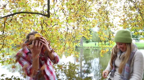 Young couple having fun in beautiful autumn park Stock Footage 57376943
