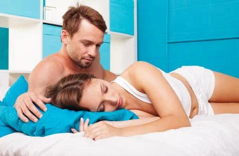 Young couple having fun in a bed Stock Photos