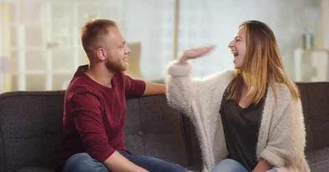 Young couple having fun on a couch Stock Footage 78030890