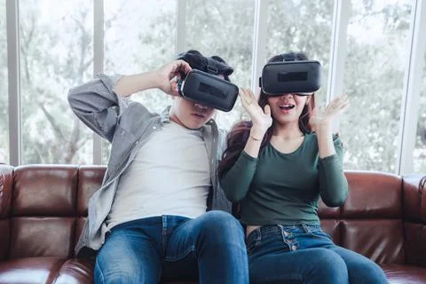 Young Couple Having Fun Exciting While Watching Video Via Virtual Reality Tog Stock Photos
