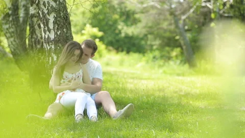 Young couple having fun on the green field in the spring or summer, general plan Stock Footage 85875916