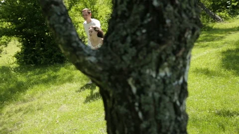 Young couple having fun on the green field in the spring or summer, general plan Stock Footage 85936508