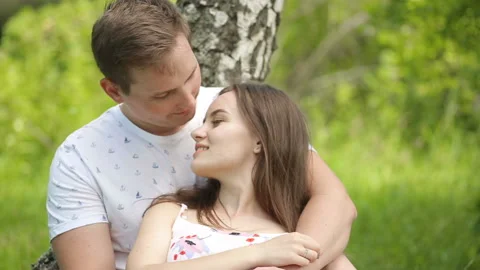 Young couple having fun on the green field in the spring or summer, general plan Stock Footage 86151102