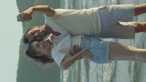 Young couple having fun hand in hand on the beach. Stock Footage 143960846