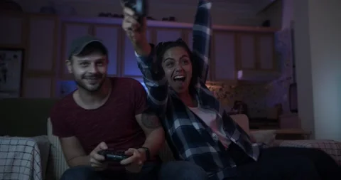 Young couple having fun at home playing game with console 스톡 동영상 141868680