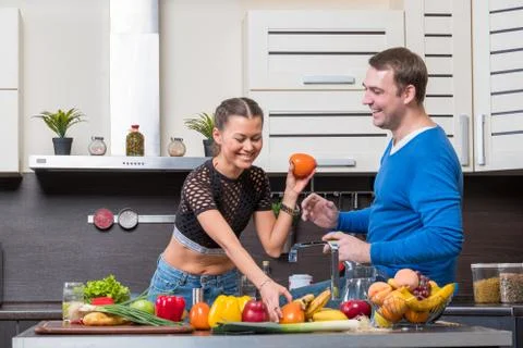 Young couple having fun in the kitchen Stock Photos