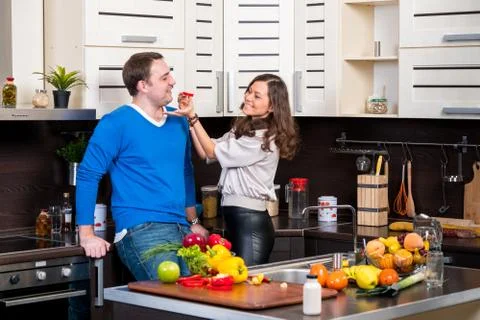 Young couple having fun in the kitchen Stock Photos