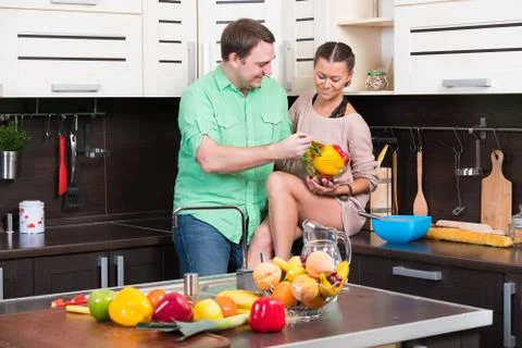 Young couple having fun in the kitchen Stock Photos