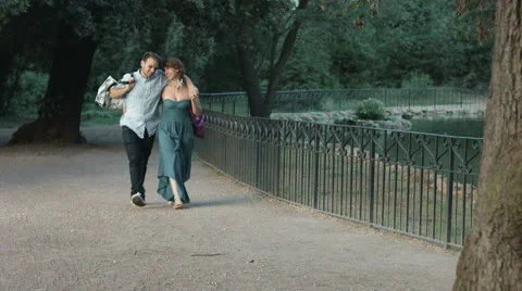 Young couple having fun in a park making jokes after shopping 스톡 동영상 41752447
