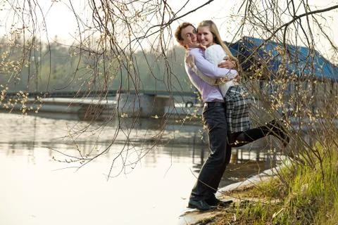 Young couple having fun at river beach Stock Photos