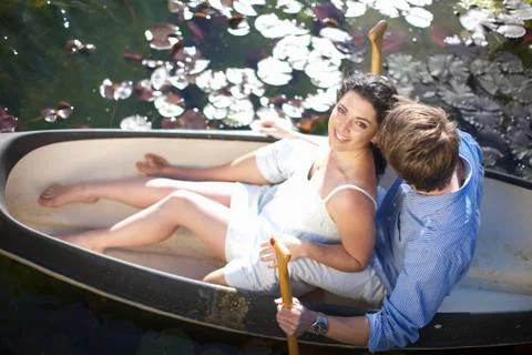 Young couple having fun in rowing boat Stock Photos