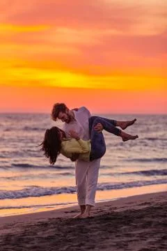 Young couple having fun on a sandy coast Stock Photos
