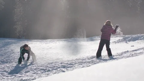 Young couple having a fun snowball fight on a sunny day Vídeo Stock 85076682