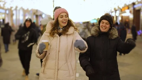 Young couple having fun on street in winter. Steadicam shot, slow motion Stock-Footage 101680904