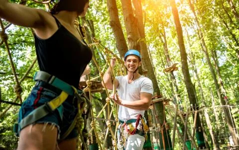 Young couple having fun time in adventure rope park. Stock Photos