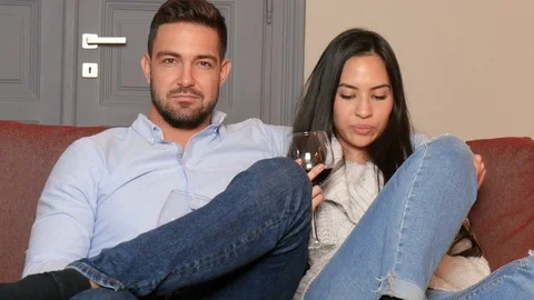 A young couple having fun watching TV together Stock Footage 85940343