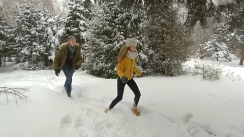 Young couple having fun in winter park Video stock 102339903