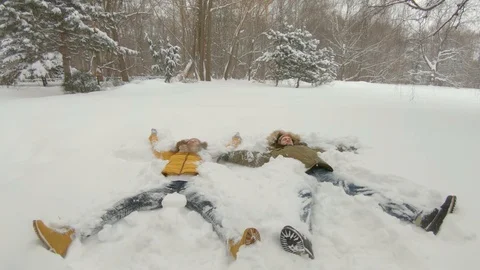 Young couple having fun in winter park Video stock 102339914