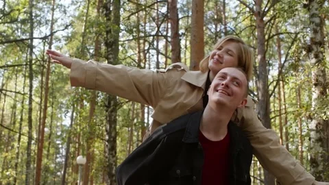 Young couple having fun in the woods Stock Footage 314631733