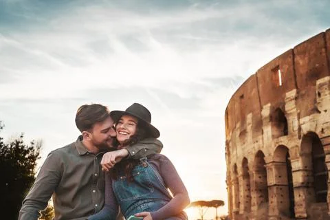 Young couple having positive emotions in Rome Colosseum Stock Photos