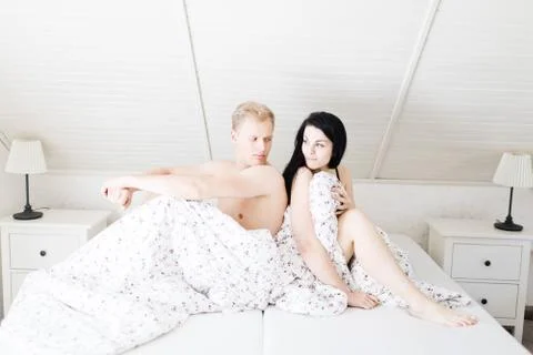 Young couple having problems in bed. Man and woman bother before intimate mom 스톡 사진