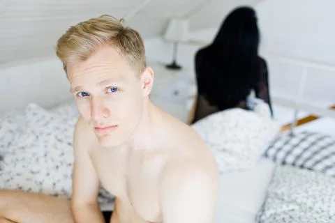 Young couple having problems in bed. Man and woman bother during intimate mom Stock Photos