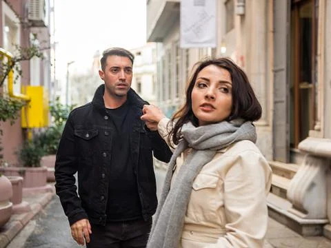 Young couple having relationships problems at street. Stock Photos