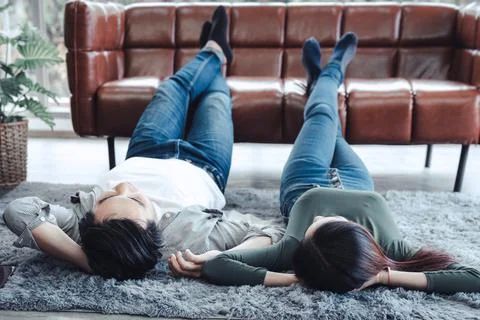 Young Couple Having Relaxing While Lying on Carpet at Their Home, Attractive  Stock Photos