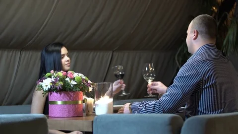 Young couple having romantic date in restaurant, drinking wine by candlelight. Stock Footage 83665248