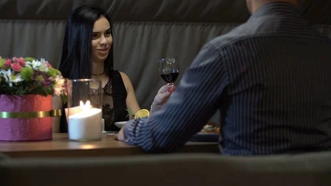 Young couple having romantic date in restaurant, drinking wine by candlelight. Stock Footage 83666018