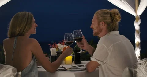 Young couple having a romantic dinner celebrating anniversary at tropical beach. Video stock 146276444
