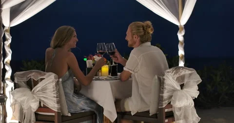 Young couple having a romantic dinner celebrating anniversary at tropical beach. Video stock 146277026