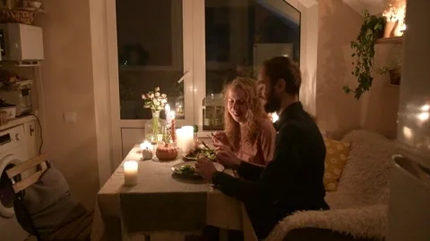 Young couple having a romantic dinner together at home by candlelight. 库存影片 330804943