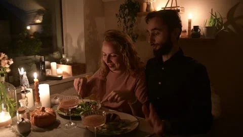 Young couple having a romantic dinner together at home by candlelight. Vídeo Stock 330805454