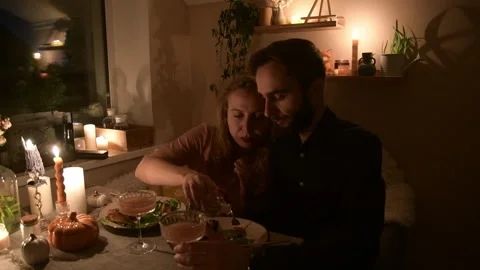 Young couple having a romantic dinner together at home by candlelight. Vídeo Stock 330805505