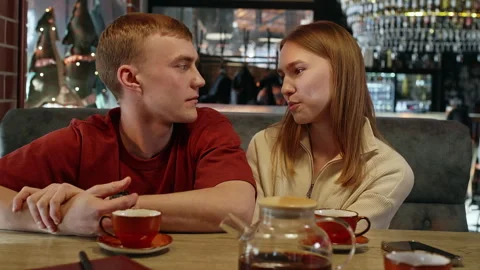 Young couple having a serious conversation at a cafe table Stock Footage 304516670