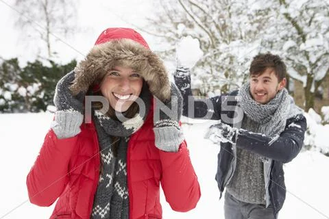 Young Couple Having Snowball Fight
