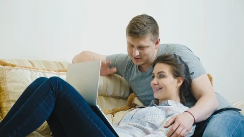 Young couple having video chat with family over laptop Stock Footage 106504576