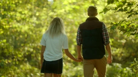 Young couple having a walk in the park Stock Footage 96236935