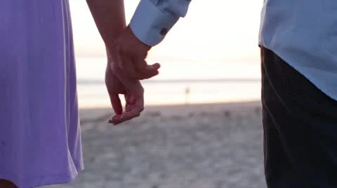 Young Couple Holding Hands on Beach Stock Footage 21888890