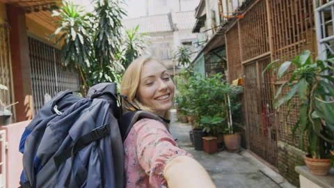 Young couple holding hands blond tourist back packer woman leading boyfriend wal Video stock 201096825