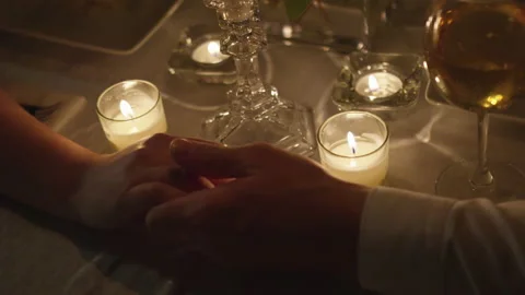 Young Couple Holding Hands During an Intimate Candlelit Dinner 스톡 동영상 208722539