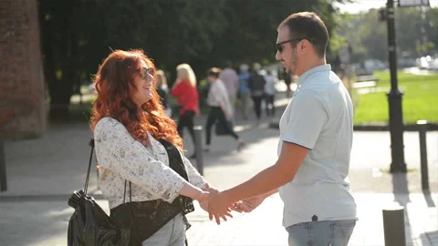 Young Couple Holding Hands As They Walk Down A City Street Together Talking And Stock Footage 101307357