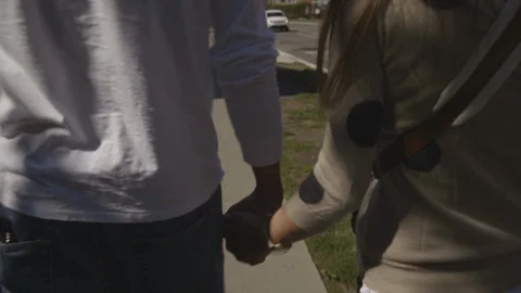 Young Couple Holding Hands While Walking Stock Footage 121288405