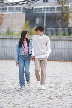 Young couple holding hands while walking outdoors. 스톡 사진
