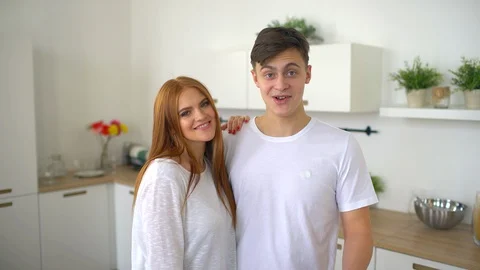 Young couple in home kitchen talking to camera. Video stock 86187086