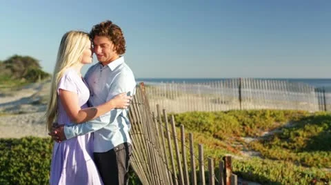 Young Couple Hugging on Beach Distant View Stock Footage 21834268
