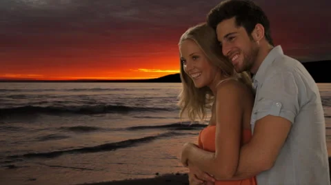 Young couple hugging on beach in sunset Stock Footage 43679691