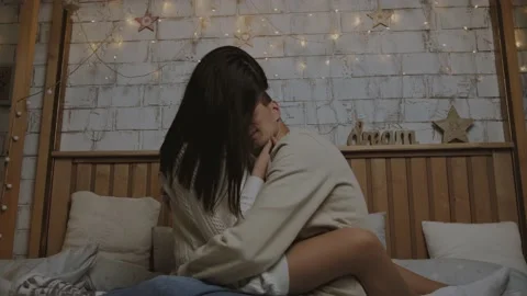 Young couple hugging on the bed  Видео 230152603